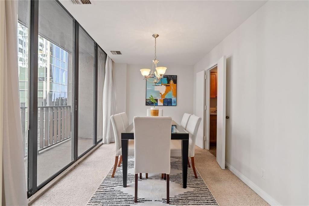 145 15th Street Northeast, Unit 602 Atlanta, GA 30361 - Photo 15 of 43 a view of a dining room with furniture window and wooden floor