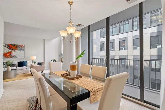 a kitchen with stainless steel appliances granite countertop white cabinets sink and dishwasher with wooden floor
