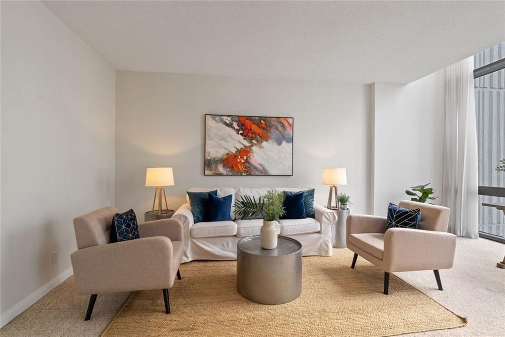 145 15th Street Northeast, Unit 602 Atlanta, GA 30361 - Photo 2 of 43 a living room with furniture and a painting on the wall