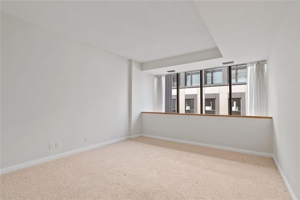 145 15th Street Northeast, Unit 602 Atlanta, GA 30361 - Photo 21 of 43 wooden floor in an empty room with a window
