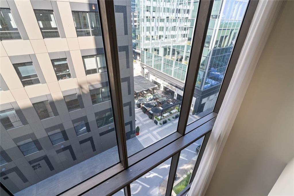 145 15th Street Northeast, Unit 602 Atlanta, GA 30361 - Photo 27 of 43 a view of a balcony with wooden floor and door