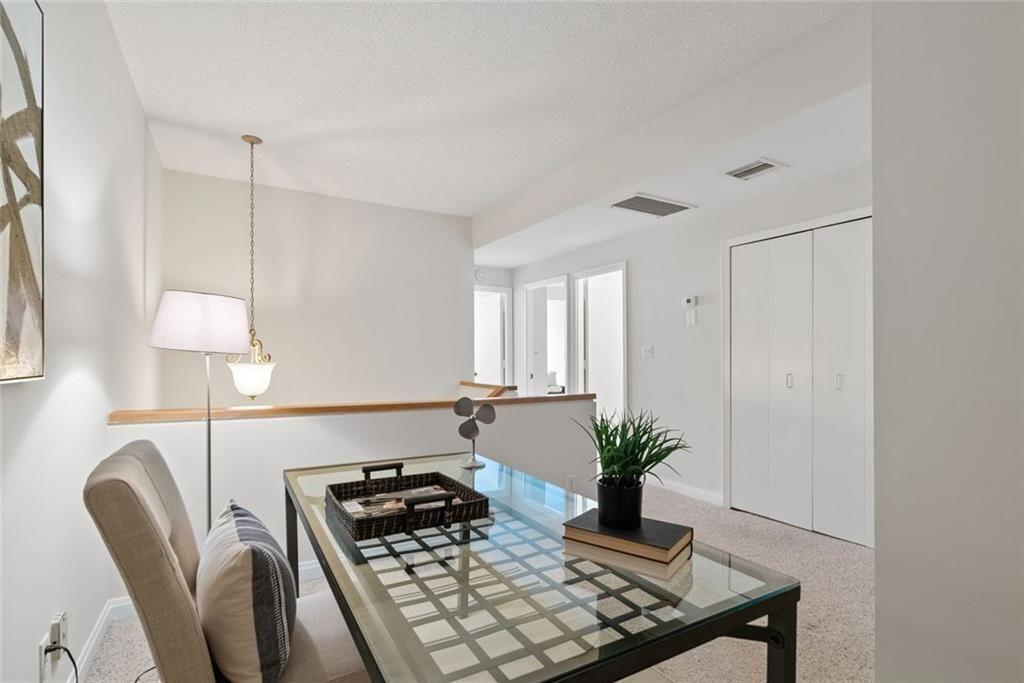 145 15th Street Northeast, Unit 602 Atlanta, GA 30361 - Photo 28 of 43 a kitchen with a stove and a chair