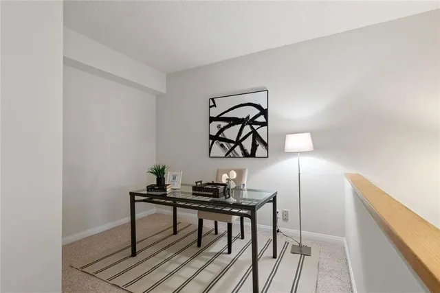 a bedroom with a bed and painting on the wall