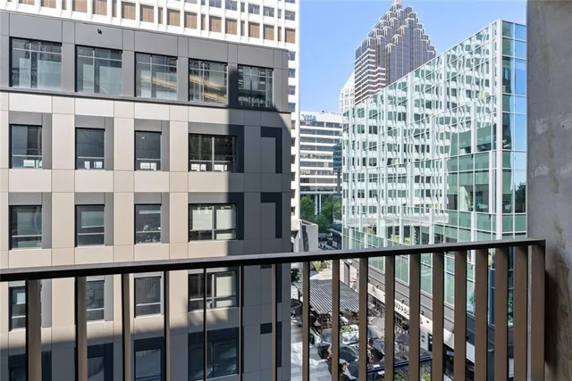 a bedroom with a bed and a lamp on dresser