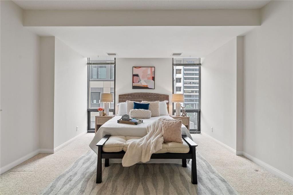 145 15th Street Northeast, Unit 602 Atlanta, GA 30361 - Photo 31 of 43 a bed room with a bed and a table