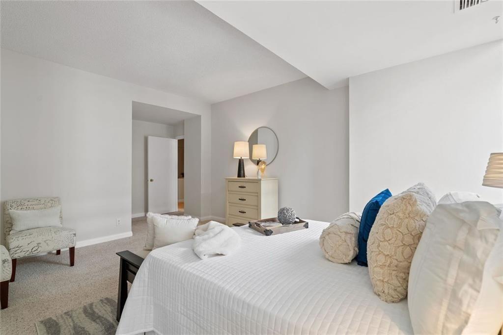 145 15th Street Northeast, Unit 602 Atlanta, GA 30361 - Photo 33 of 43 a bedroom with a bed and painting on the wall