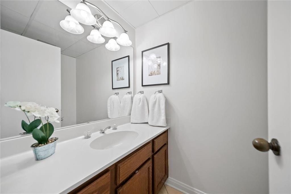 145 15th Street Northeast, Unit 602 Atlanta, GA 30361 - Photo 38 of 43 a bathroom with a sink a light fixture and a mirror