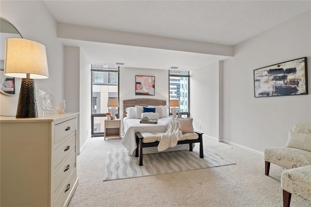 145 15th Street Northeast, Unit 602 Atlanta, GA 30361 - Photo 40 of 43 a bed room with a bed and a lamp