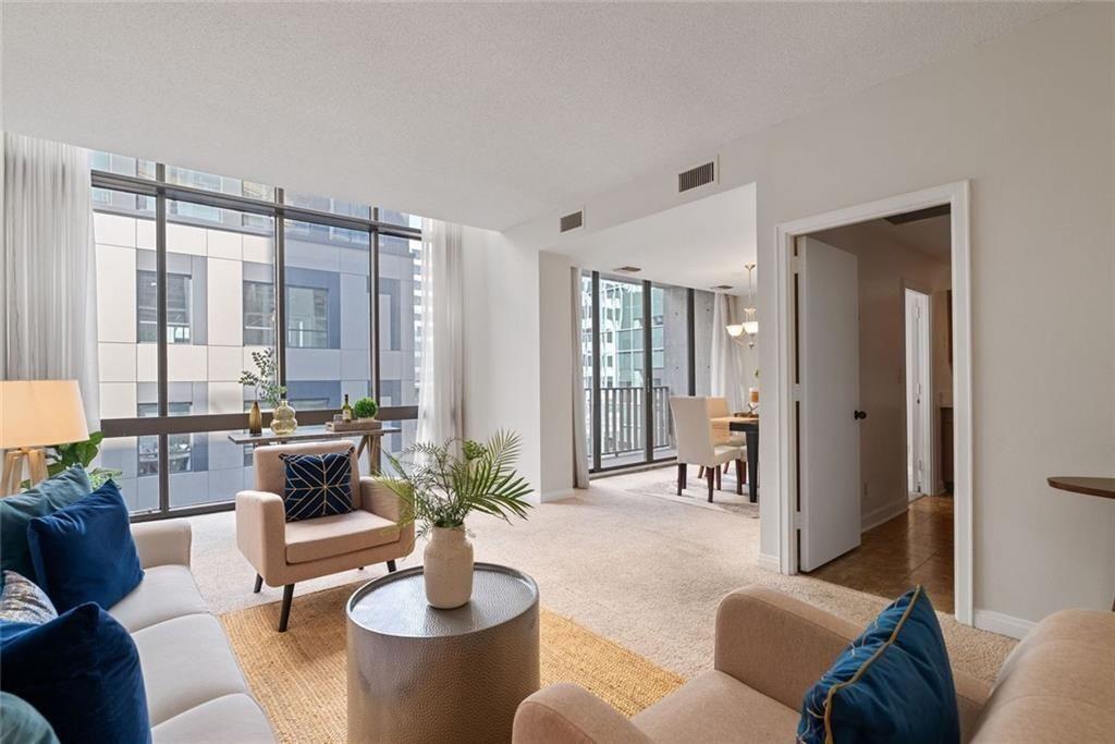 145 15th Street Northeast, Unit 602 Atlanta, GA 30361 - Photo 4 of 43 a living room with furniture and a large window