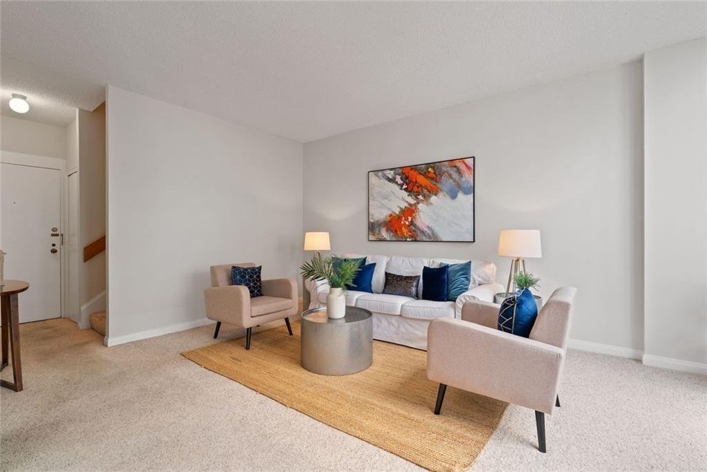 145 15th Street Northeast, Unit 602 Atlanta, GA 30361 - Photo 10 of 43 a living room with furniture and a painting on the wall
