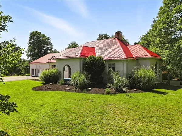 a front view of house with yard and green space