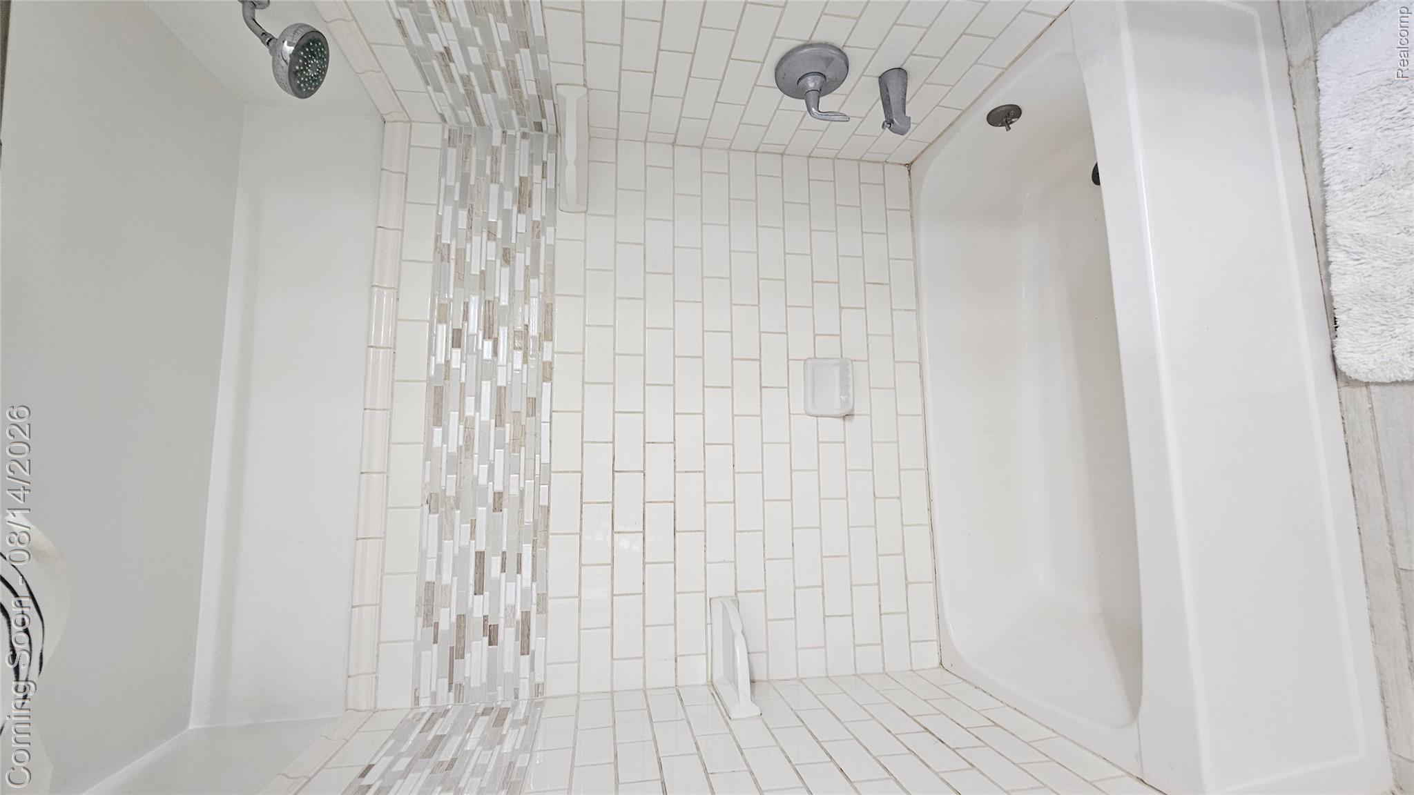7966 Pettysville Road Pinckney, MI 48169 - Photo 28 of 43 Bathtub with subway tile surround, mosaic tile accent band, and chrome shower fixtures