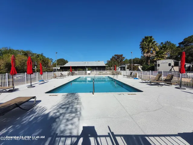 a view of a swimming pool with lounge chairs