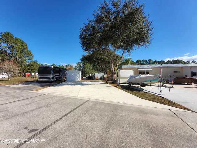 a view of a street with a cars parked on the road