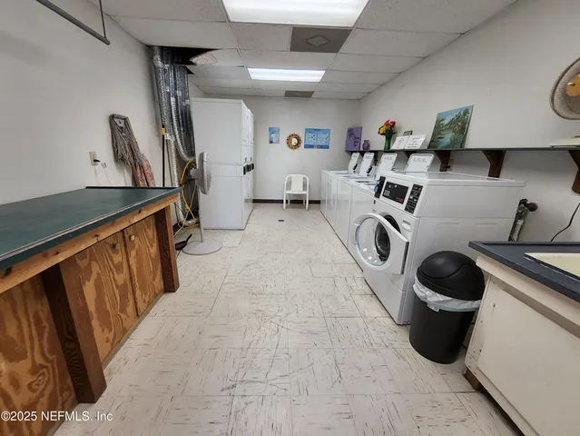 a utility room with sink dryer and washer