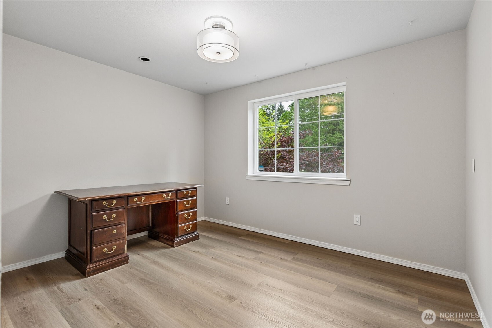 608 School Street Southeast Lacey, WA 98503 - Photo 11 of 26 an empty room with wooden floor and windows