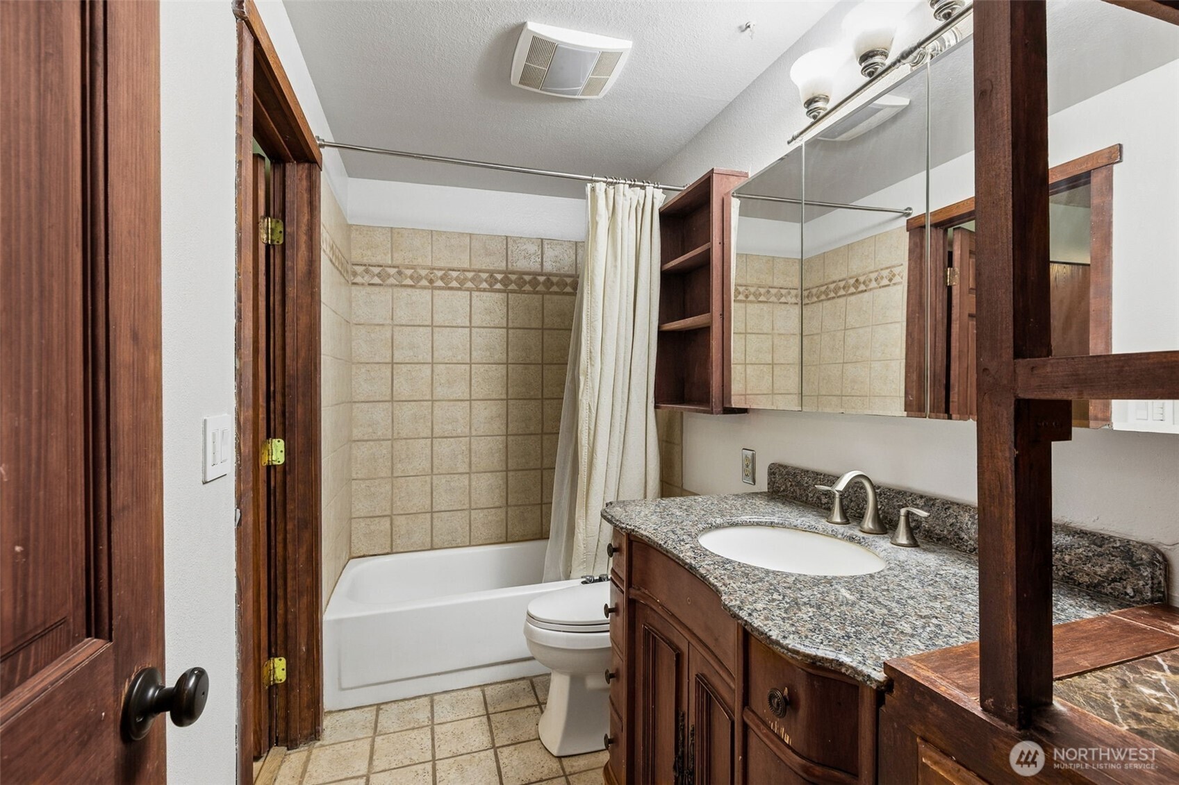 608 School Street Southeast Lacey, WA 98503 - Photo 15 of 26 a bathroom with a granite countertop sink toilet and shower