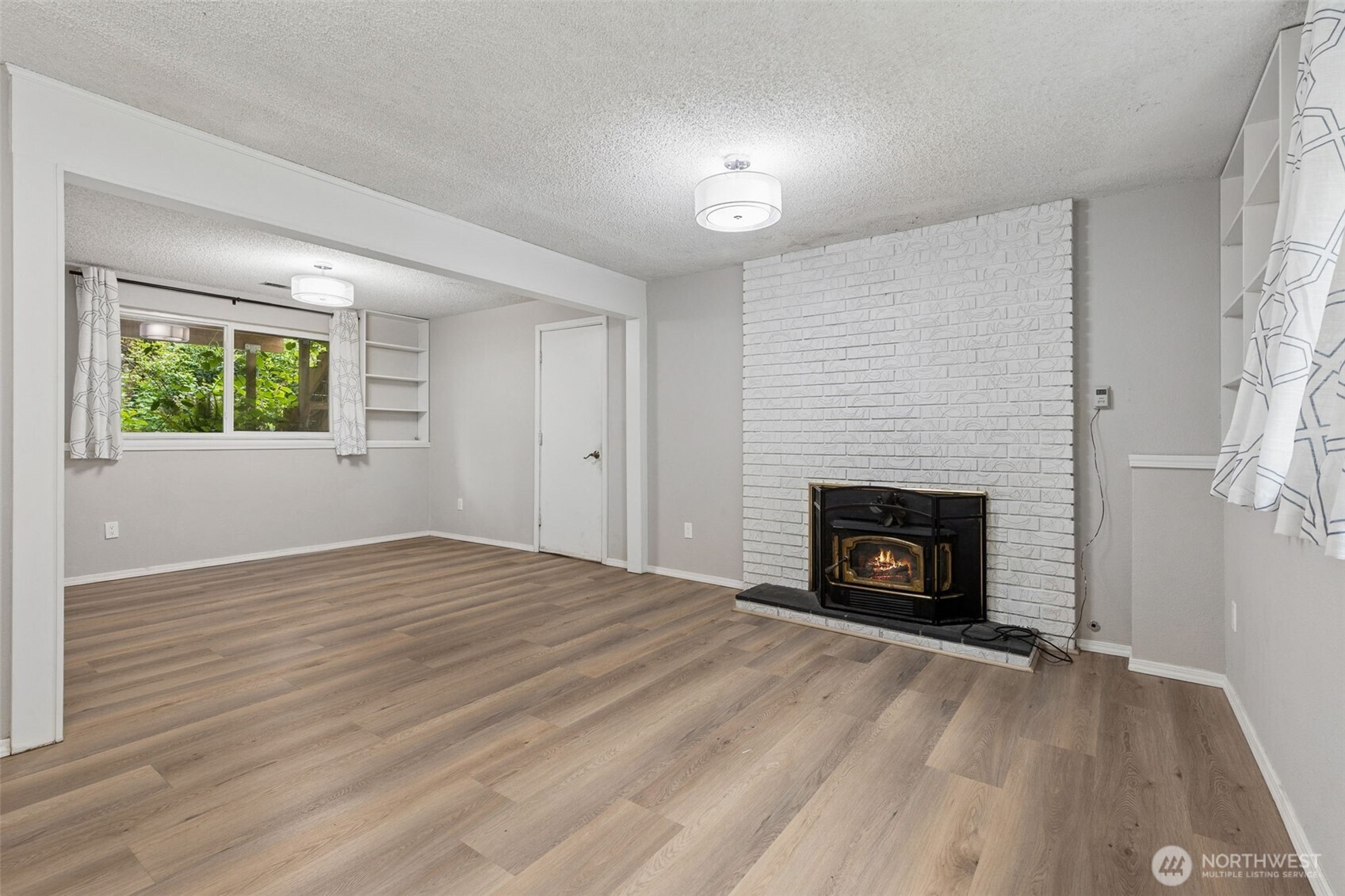 608 School Street Southeast Lacey, WA 98503 - Photo 16 of 26 an empty room with windows and a fireplace