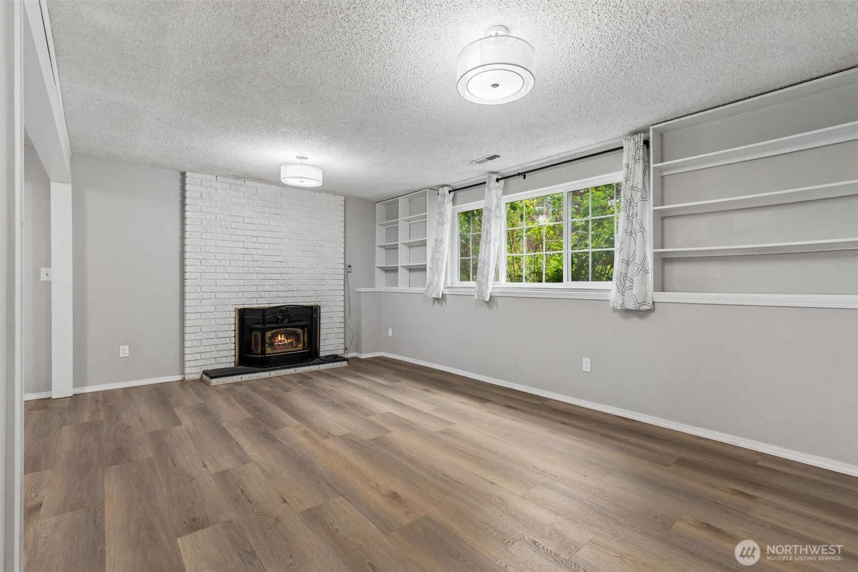 608 School Street Southeast Lacey, WA 98503 - Photo 18 of 26 an empty room with windows and fireplace