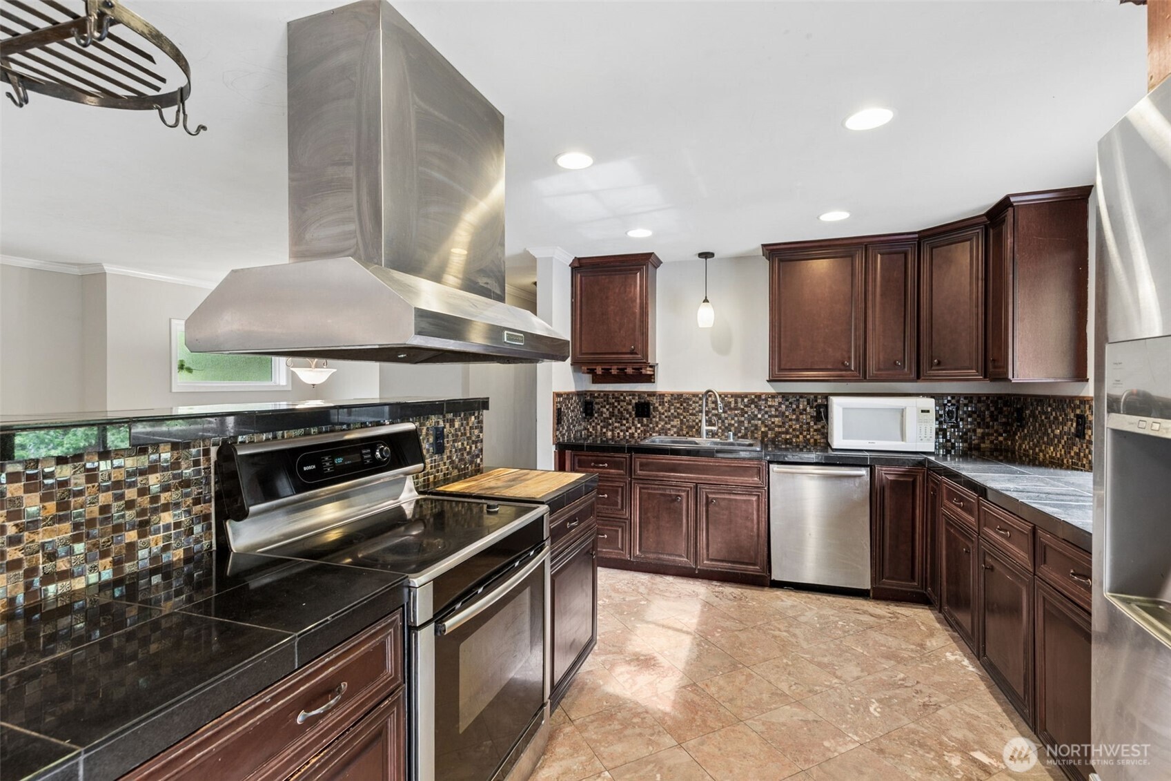 608 School Street Southeast Lacey, WA 98503 - Photo 6 of 26 a kitchen with a stove a sink and a microwave