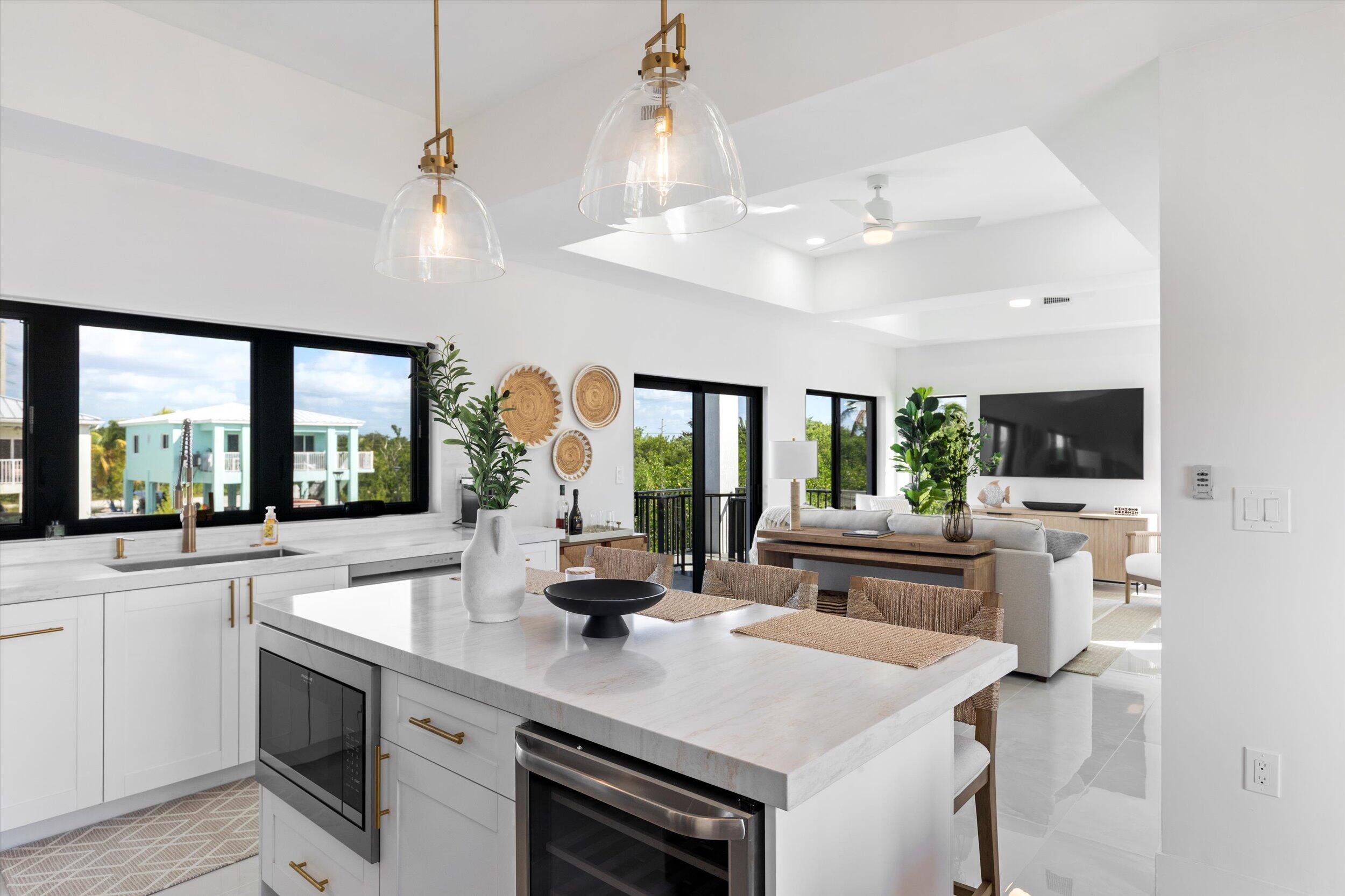 27433 Antigua Road Summerland Key, FL 33042 - Photo 27 of 64 a kitchen with a stove a sink and a refrigerator