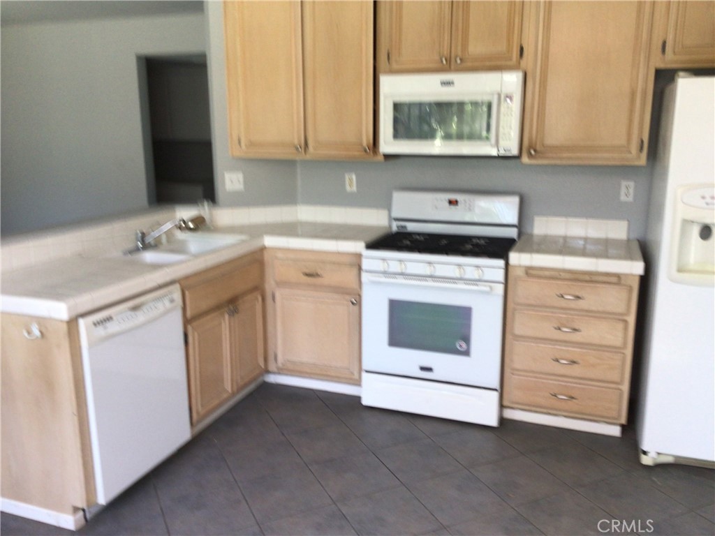 763 Anthirium Avenue Perris, CA 92571 - Photo 11 of 20 a kitchen with cabinets appliances and a sink