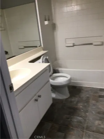 a bathroom with a sink a toilet and bathtub