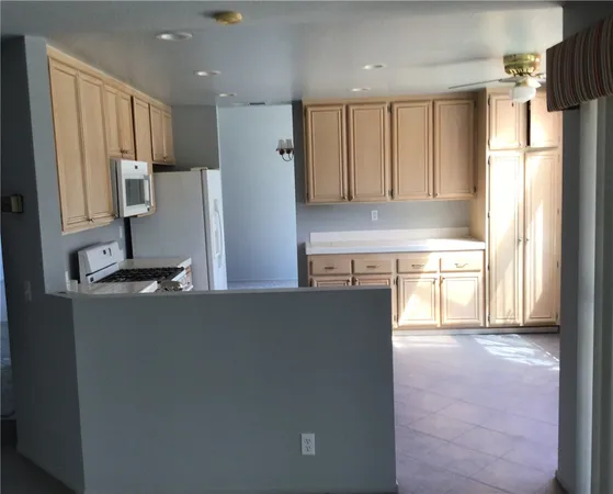 a kitchen with stainless steel appliances granite countertop a refrigerator a sink dishwasher and a stove