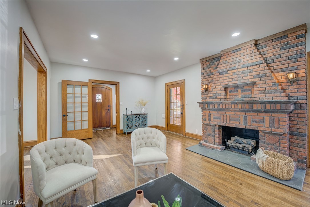 6197 Turney Road Cleveland, OH 44125 - Photo 3 of 35 Living room featuring a large fireplace, light wood-type flooring, and french doors