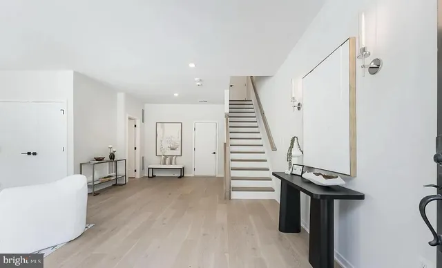 a living room with furniture and floor to ceiling windows