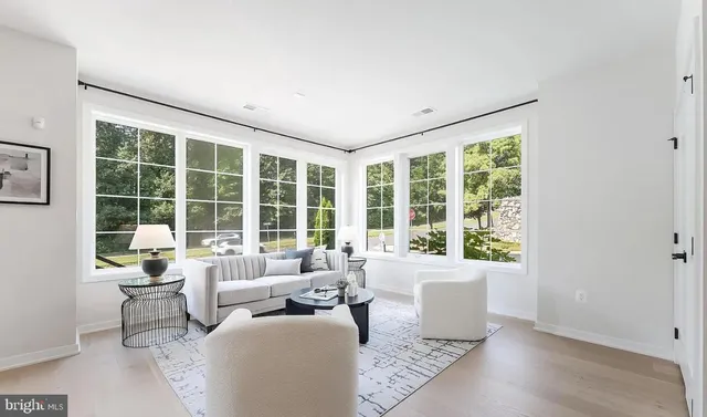 a living room with furniture and large windows