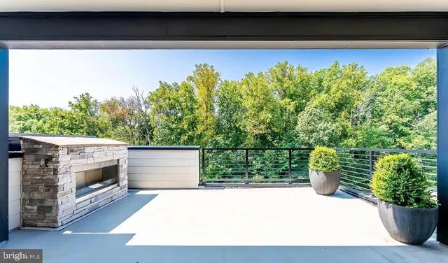 a kitchen with stainless steel appliances a table chairs and a clock