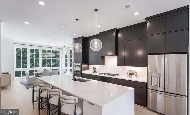 a dining room with furniture a large window and a chandelier
