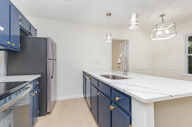 a kitchen with a sink and a refrigerator