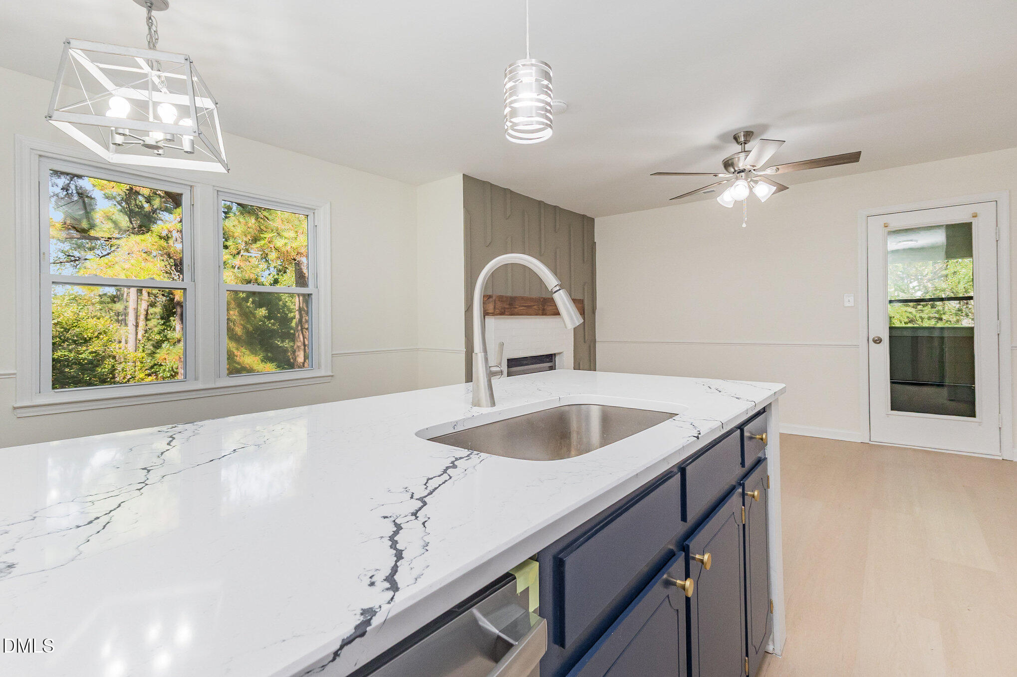 3559 Mill Run Raleigh, NC 27612 - Photo 13 of 28 a kitchen with a sink and chandelier