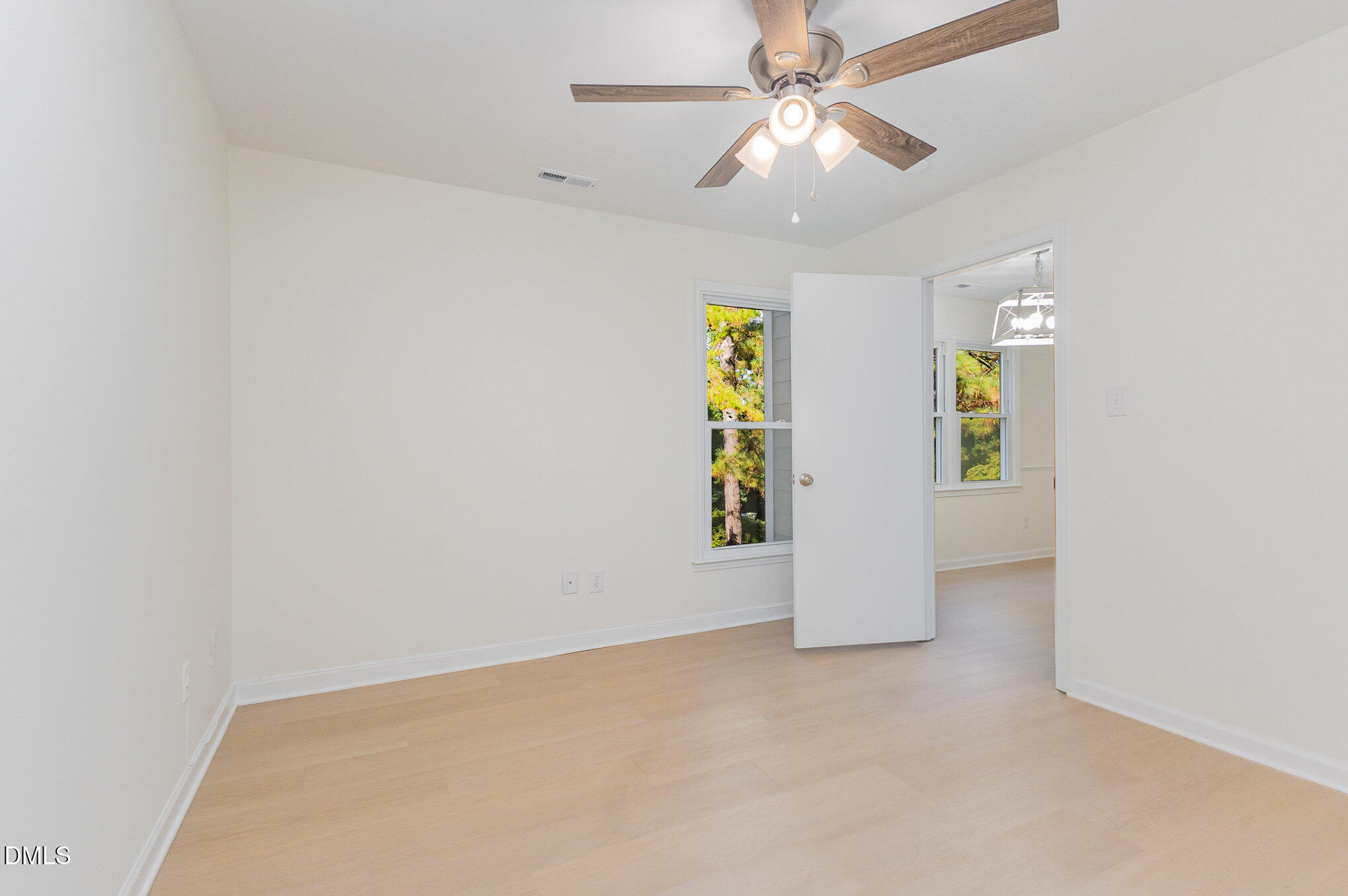 3559 Mill Run Raleigh, NC 27612 - Photo 14 of 28 an empty room with yellow walls and ceiling fan
