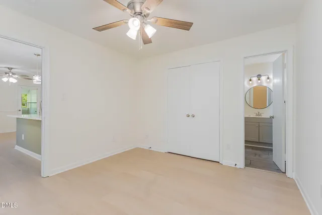 wooden floor in an empty room and a chandelier fan
