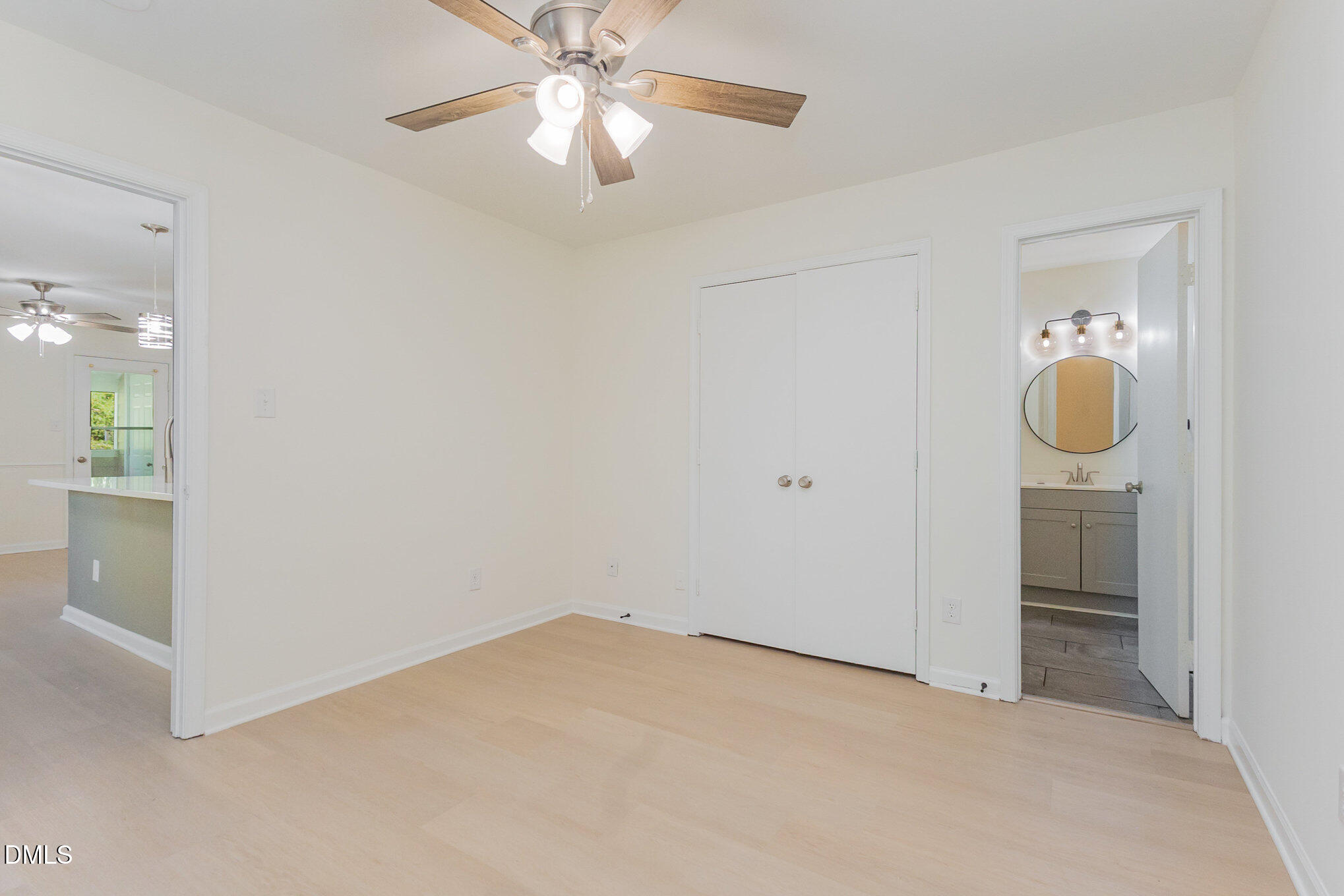 3559 Mill Run Raleigh, NC 27612 - Photo 15 of 28 wooden floor in an empty room and a chandelier fan