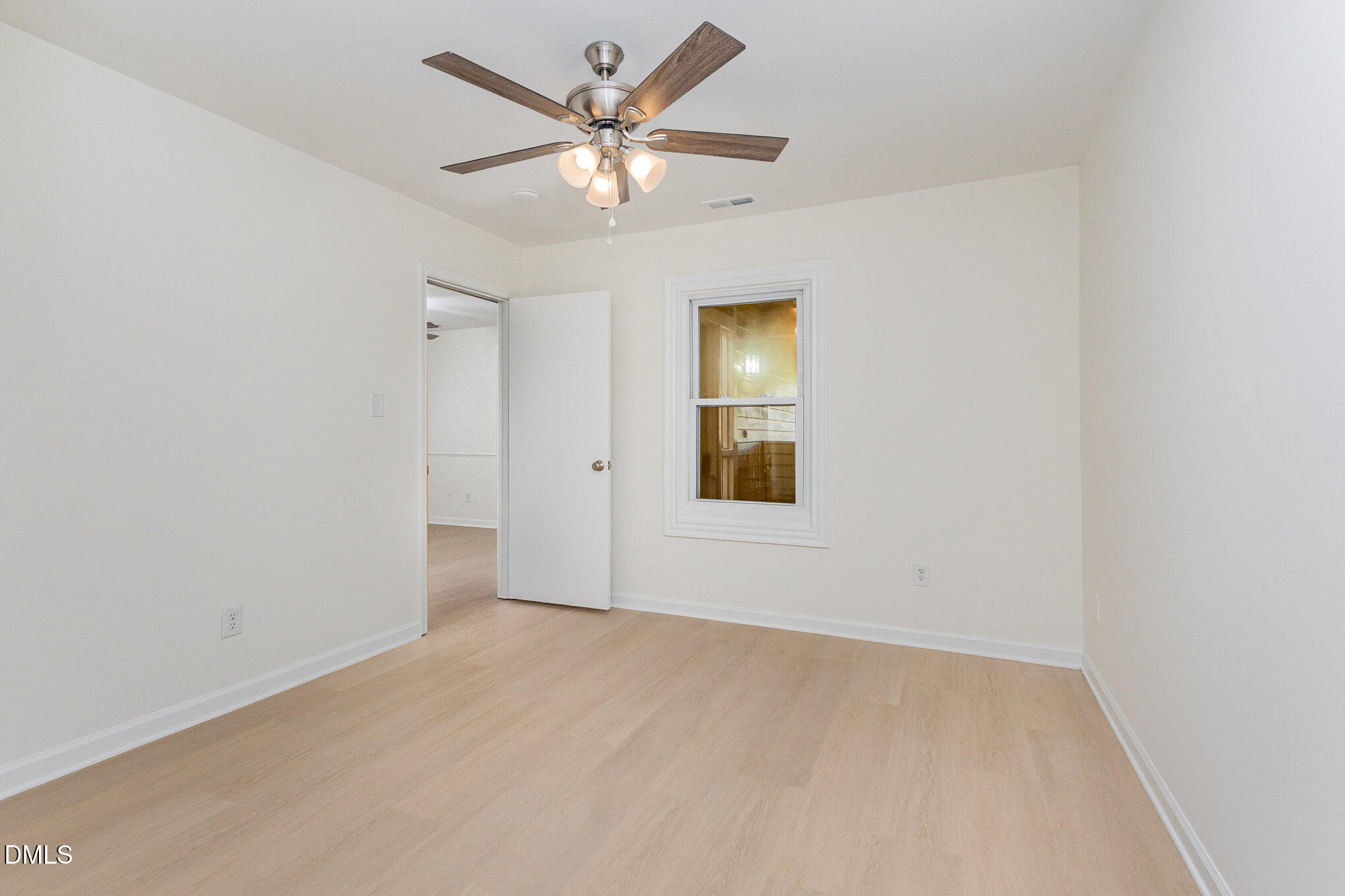 3559 Mill Run Raleigh, NC 27612 - Photo 18 of 28 an empty room with a window and a fan