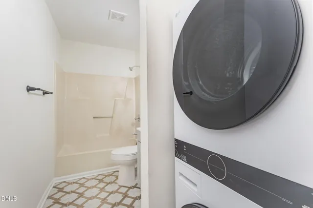 a bathroom with a toilet and a mirror