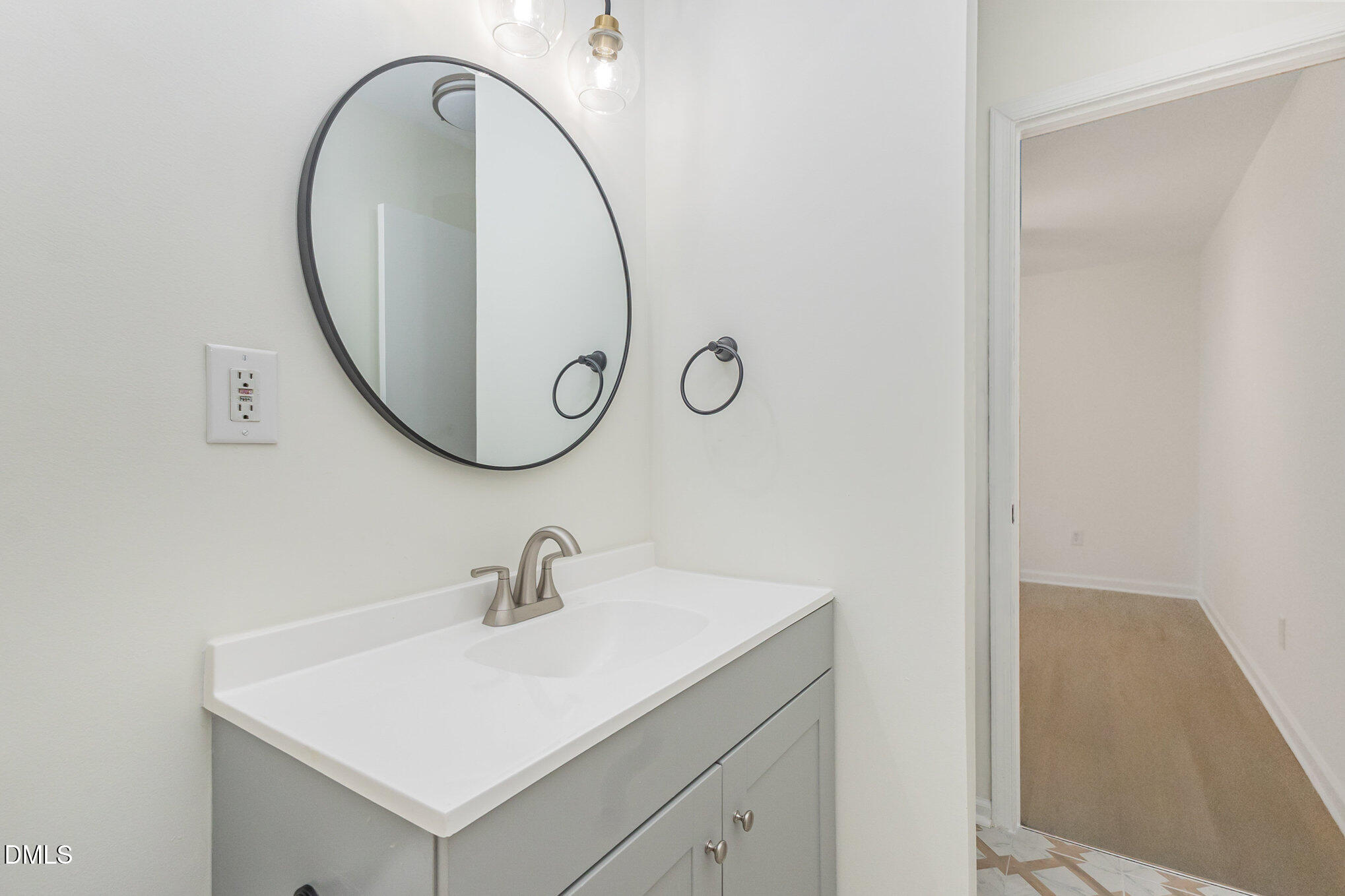 3559 Mill Run Raleigh, NC 27612 - Photo 22 of 28 a bathroom with a sink and a mirror
