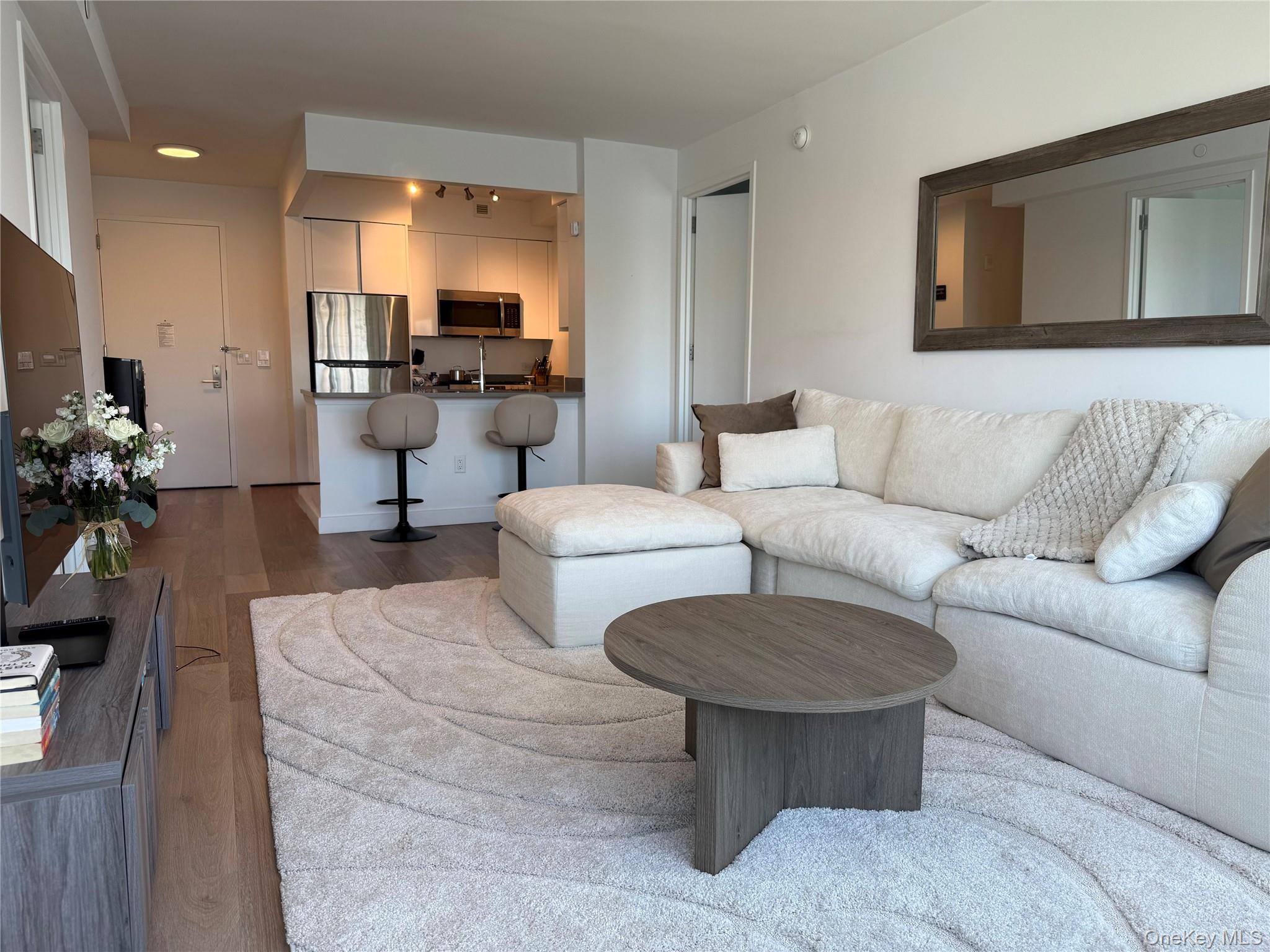 52-03 Center Boulevard, Unit 928 Queens, NY 11101 - Photo 4 of 13 a living room with furniture and a table