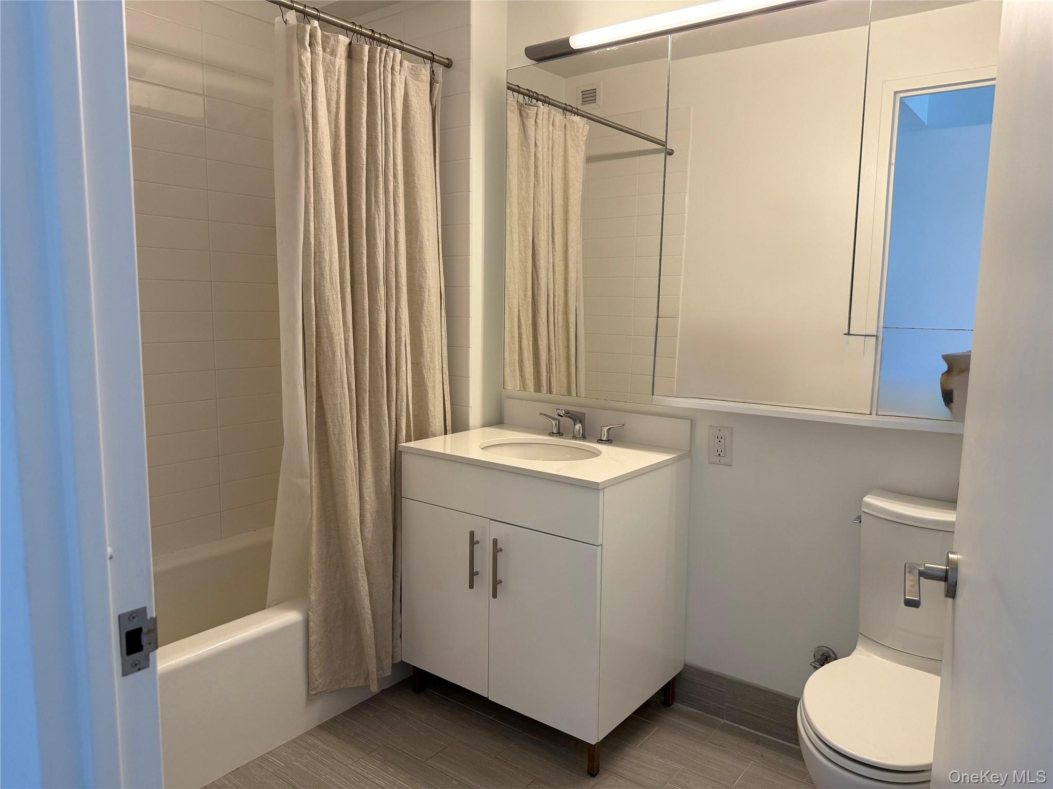 52-03 Center Boulevard, Unit 928 Queens, NY 11101 - Photo 8 of 13 a bathroom with a sink a toilet and shower