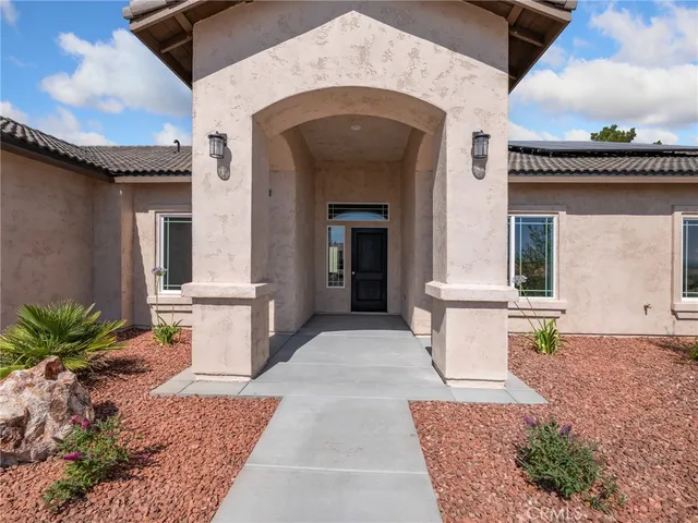 a front view of a house with outdoor seating