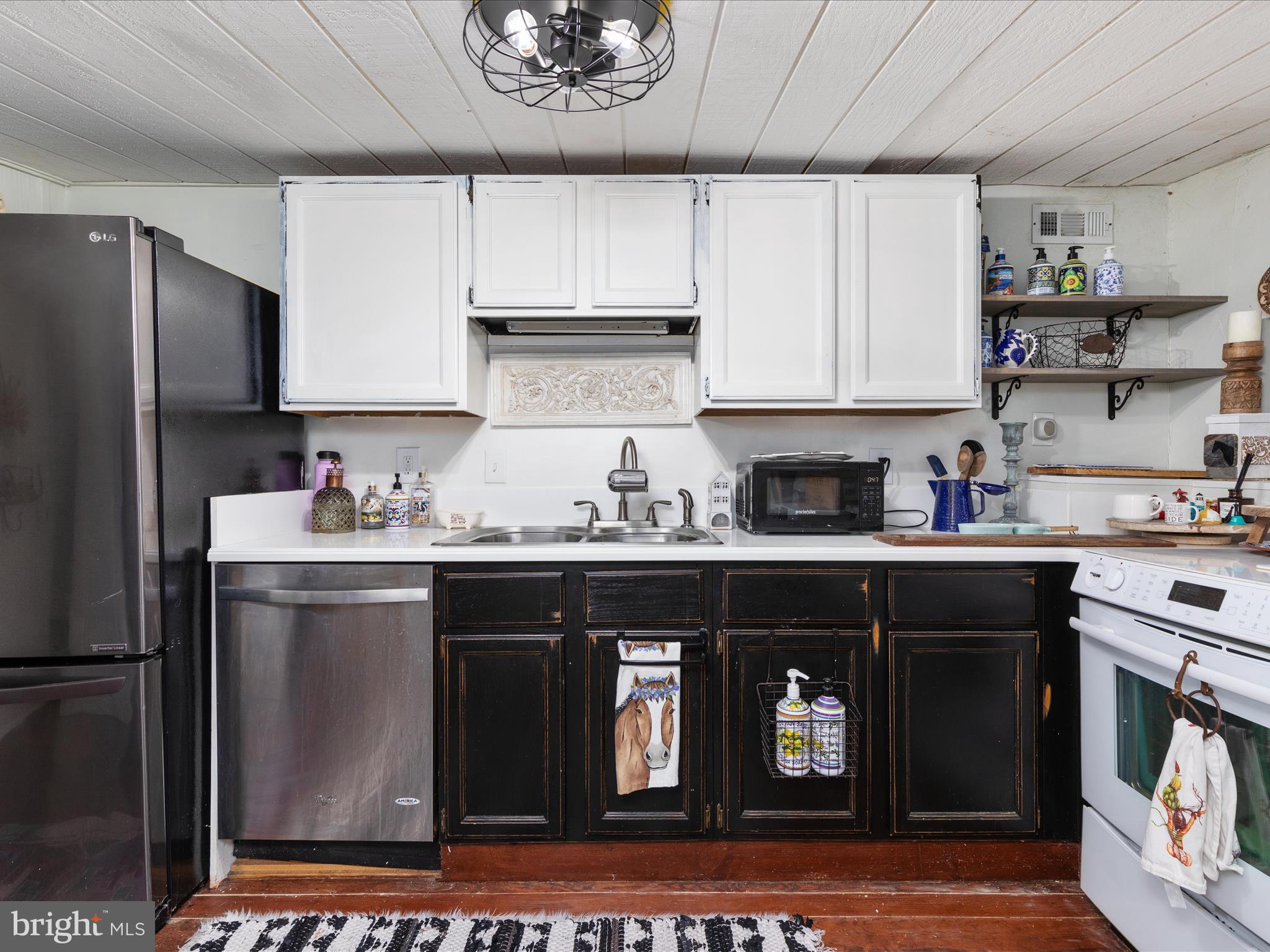 36610 Philomont Road Purcellville, VA 20132 - Photo 26 of 61 a kitchen with stainless steel appliances granite countertop a refrigerator a sink dishwasher and white cabinets with wooden floor