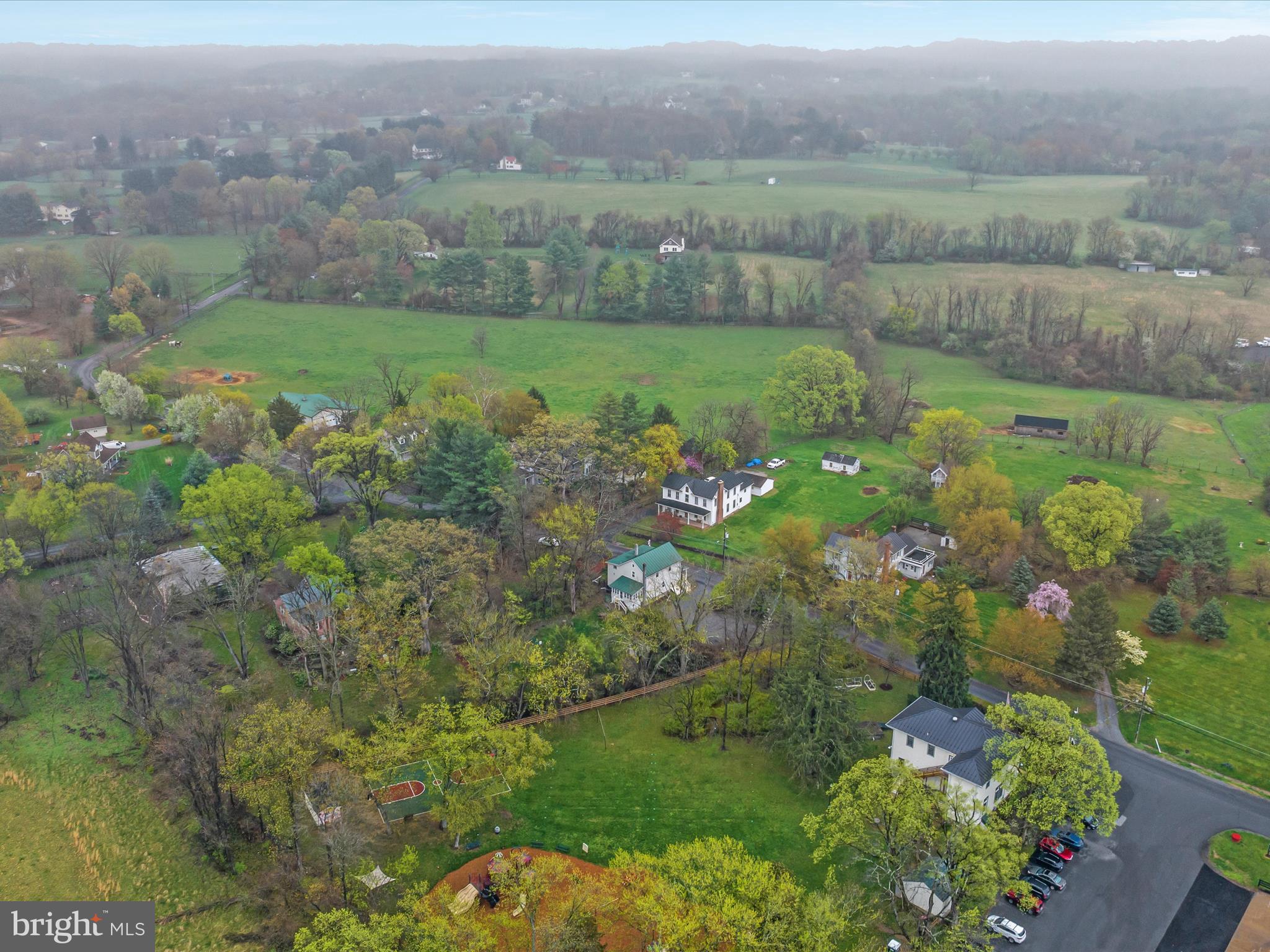 36610 Philomont Road Purcellville, VA 20132 - Photo 39 of 61 a view of a lush green forest with a houses