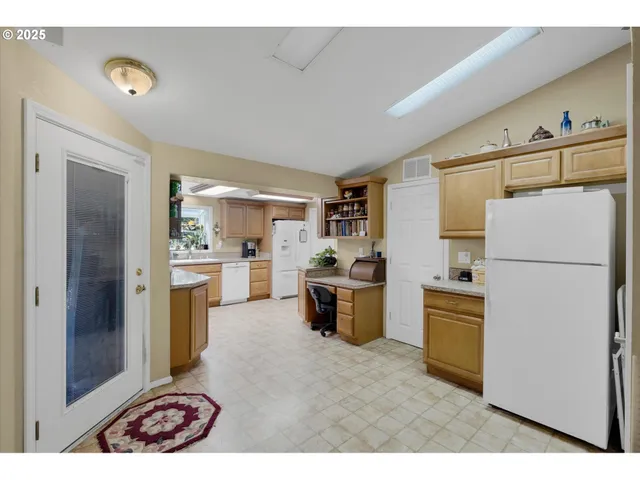 a kitchen with refrigerator cabinets and a table