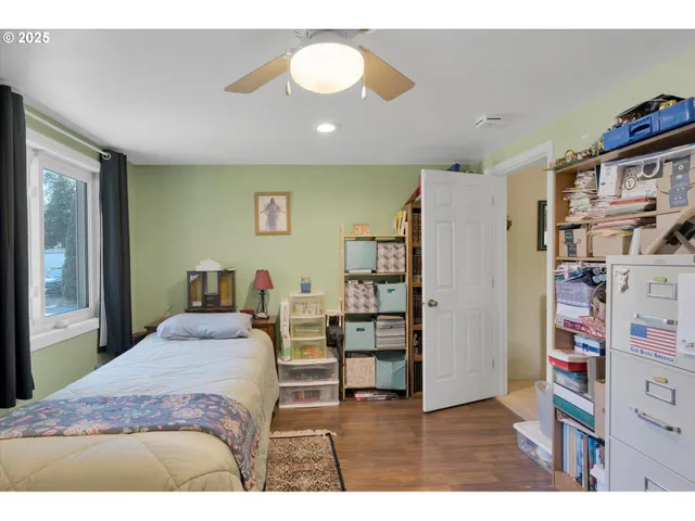 a bedroom with a bed and a book shelf