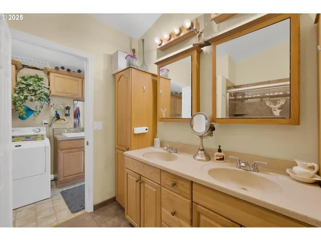 a bathroom with a sink double vanity and a mirror