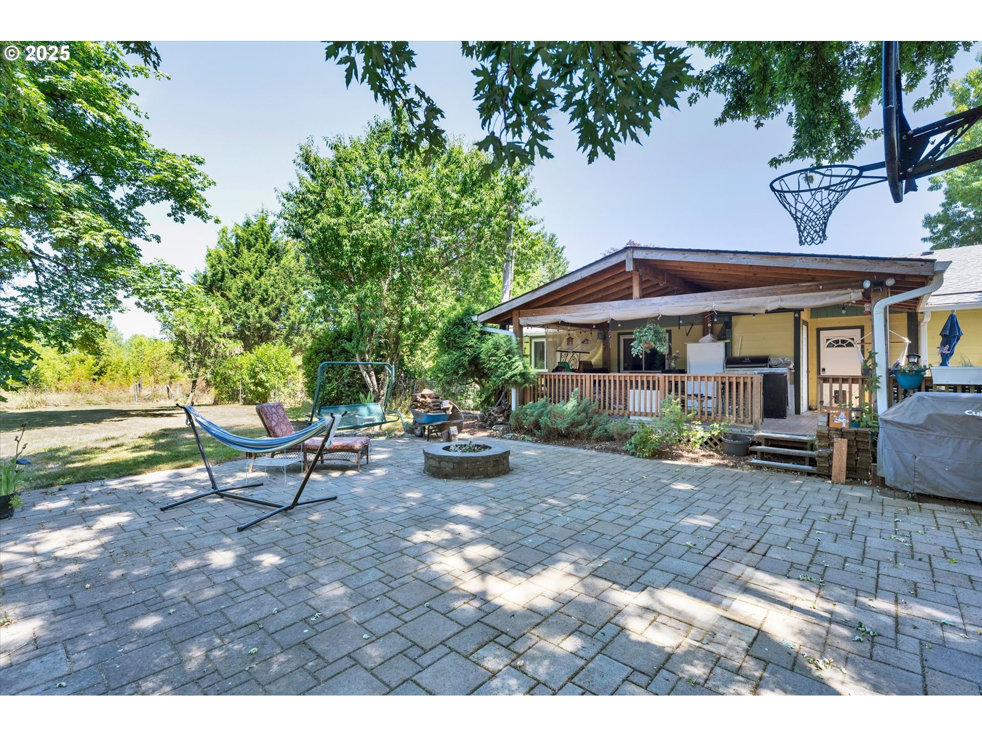 10025 Northeast Ward Road Brush Prairie, WA 98606 - Photo 23 of 33 a view of a patio with a table and chairs under an umbrella